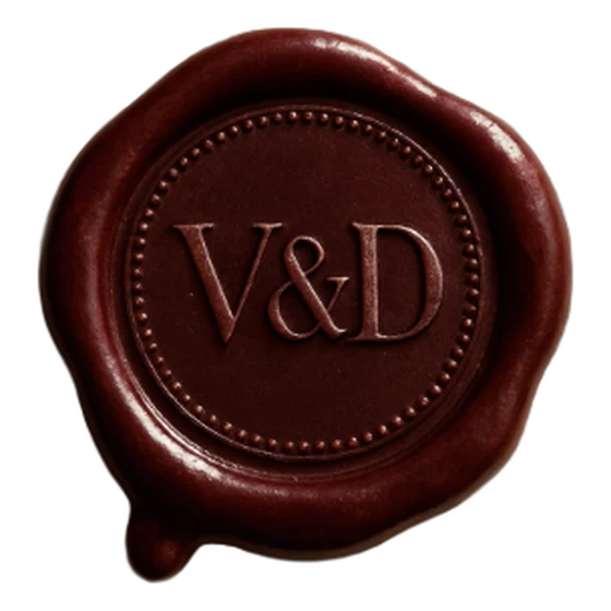 A deep burgundy wax seal with the initials V & D, designed in the Seal Studio